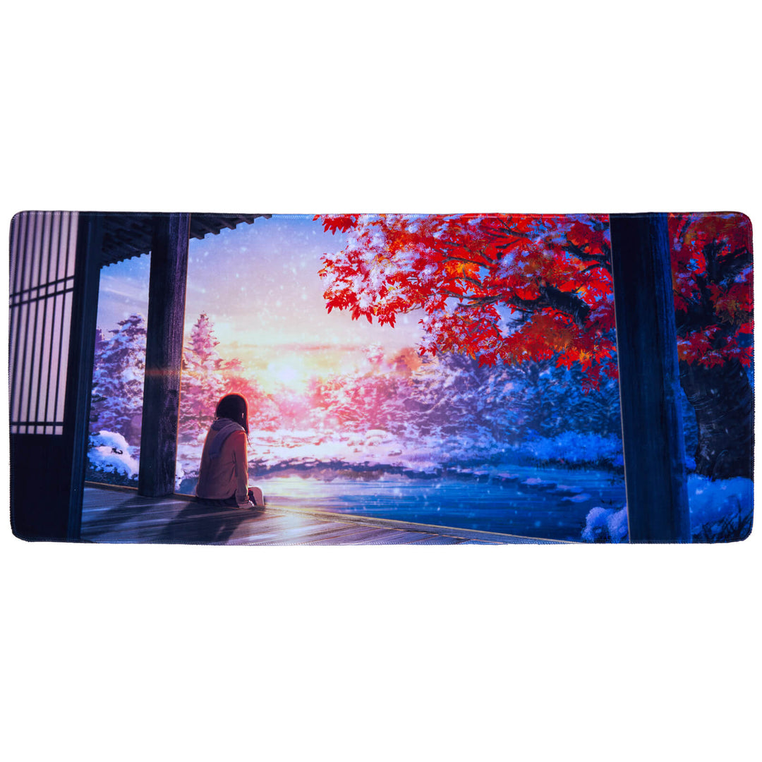 Falling Snow desk mat, measuring 400x900x3mm, portraying a contemplative scene of a young girl by a house gazing over snowy landscapes, evoking a sense of winter nostalgia and wonder for your workspace.