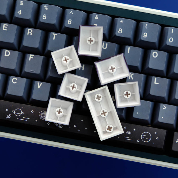 Galaxy keycap set elegantly installed in a keyboard, featuring celestial and cosmic designs in deep blues, creating a mesmerizing and otherworldly visual theme for your typing experience