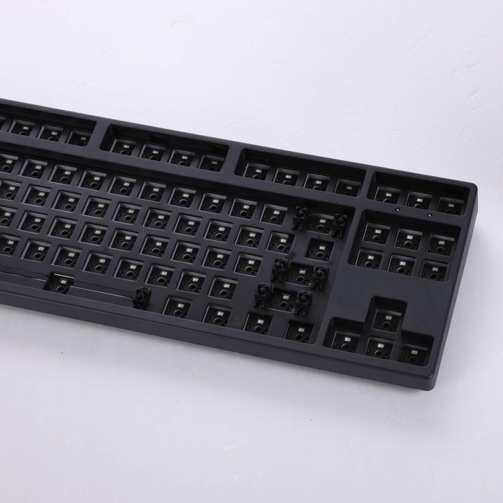 Black barebones keyboard featuring 87 keys, providing a sleek and compact typing solution with essential functionality.