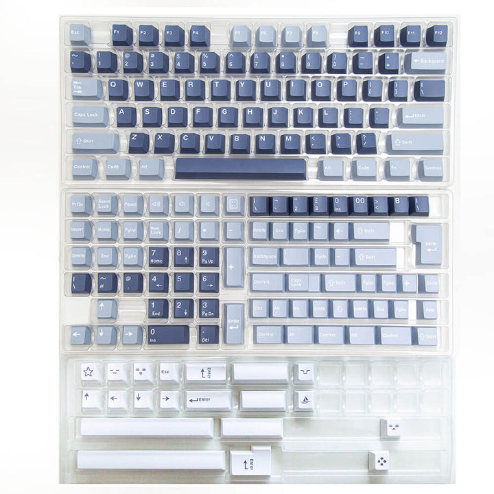 Fishing keycap set shown in its packaging, featuring a harmonious blend of multiple shades of blue and white colors, reminiscent of serene aquatic scenes, offering a tranquil and maritime-inspired aesthetic for your keyboard.