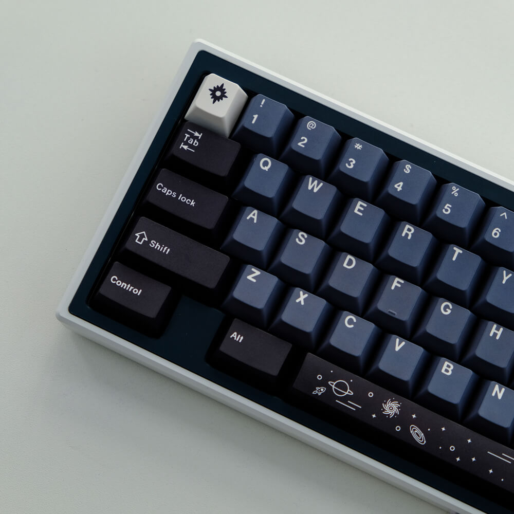 Galaxy keycap set elegantly installed in a keyboard, featuring celestial and cosmic designs in deep blues, creating a mesmerizing and otherworldly visual theme for your typing experience