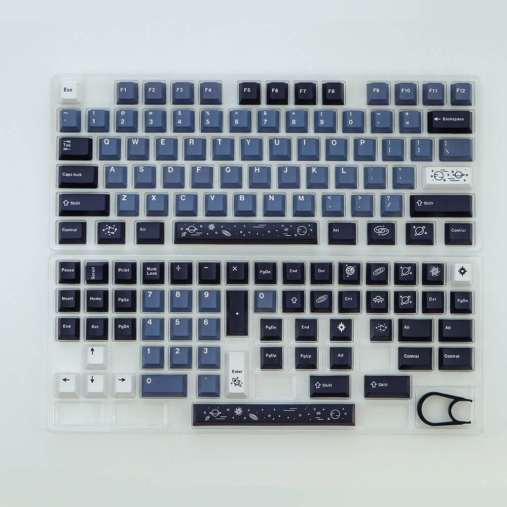 Galaxy keycap set shown in its packaging, elegantly installed in a keyboard, featuring celestial and cosmic designs in deep blues, creating a mesmerizing and otherworldly visual theme for your typing experience
